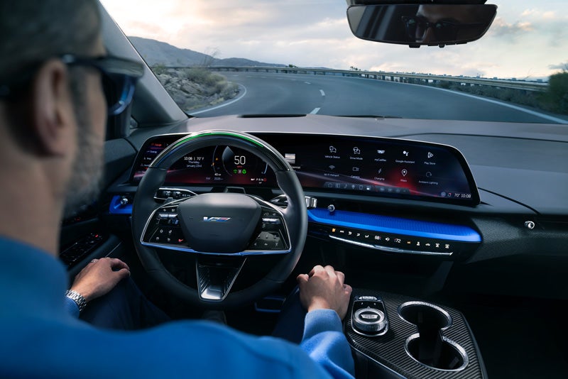 Front View of the 2026 OPTIQ-V Driving Through the Dusk Utilizing its Headlights | Valenti Cadillac in Hartford CT